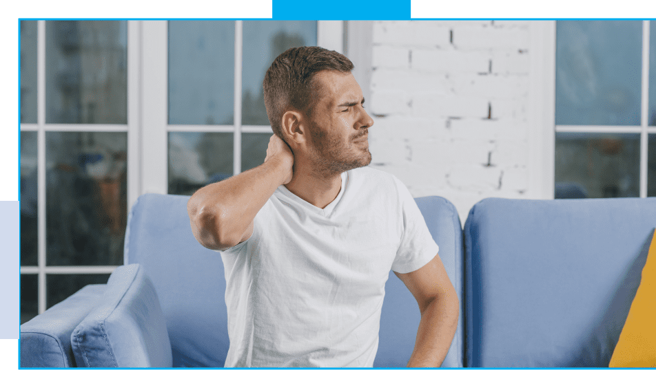 A man sitting on top of a blue chair with his hands behind his head.