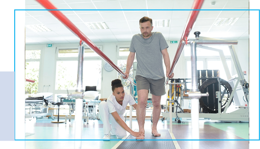 A man and woman are standing in the gym