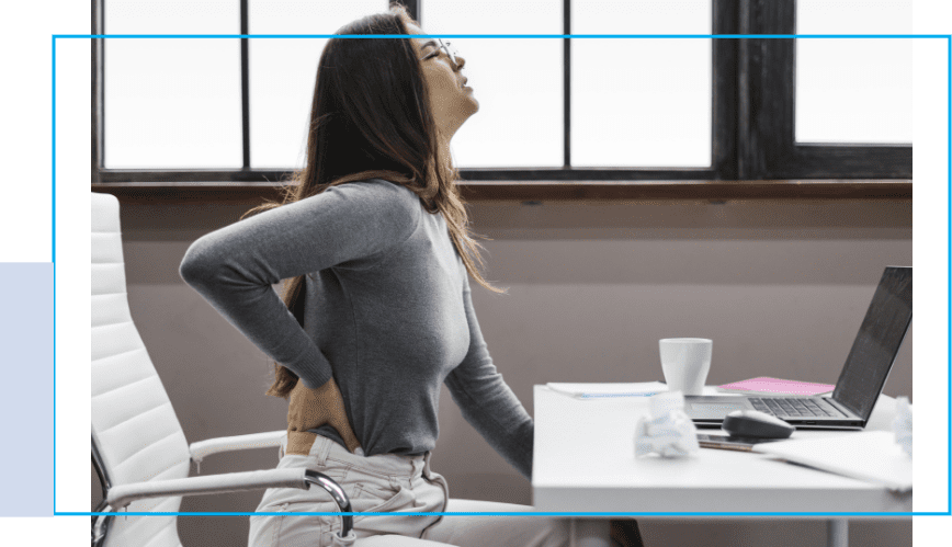 A woman sitting at her desk with her back turned.