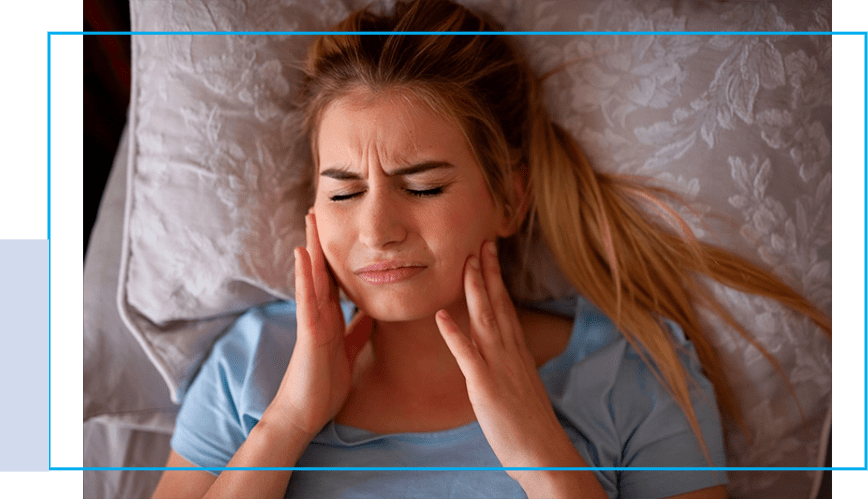 A woman laying in bed with her eyes closed.