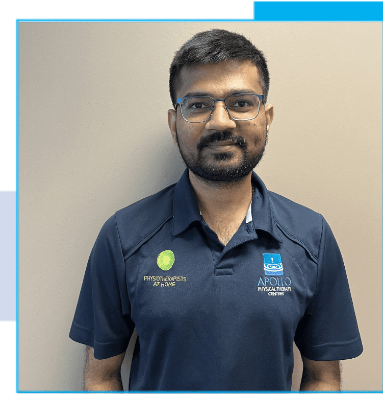 A man in blue shirt standing next to wall.